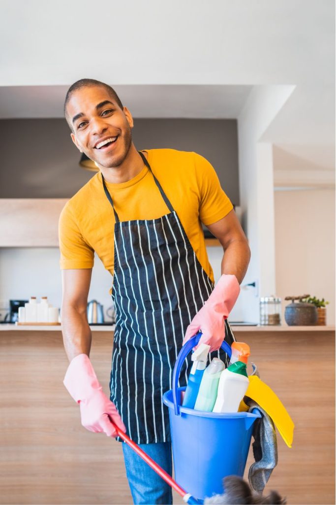 Professional maid with cleaning supplies