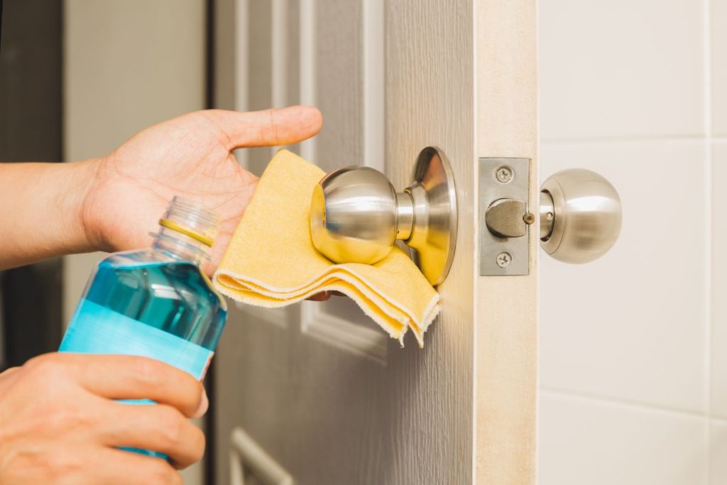 hand cleaning doorknob